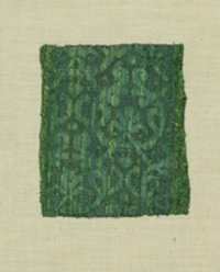 Grünes Samtgewebe mit symmetrischen Mustern