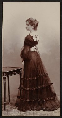 Gerty von Hofmannsthal im Profil stehend im dunklen Kleid
